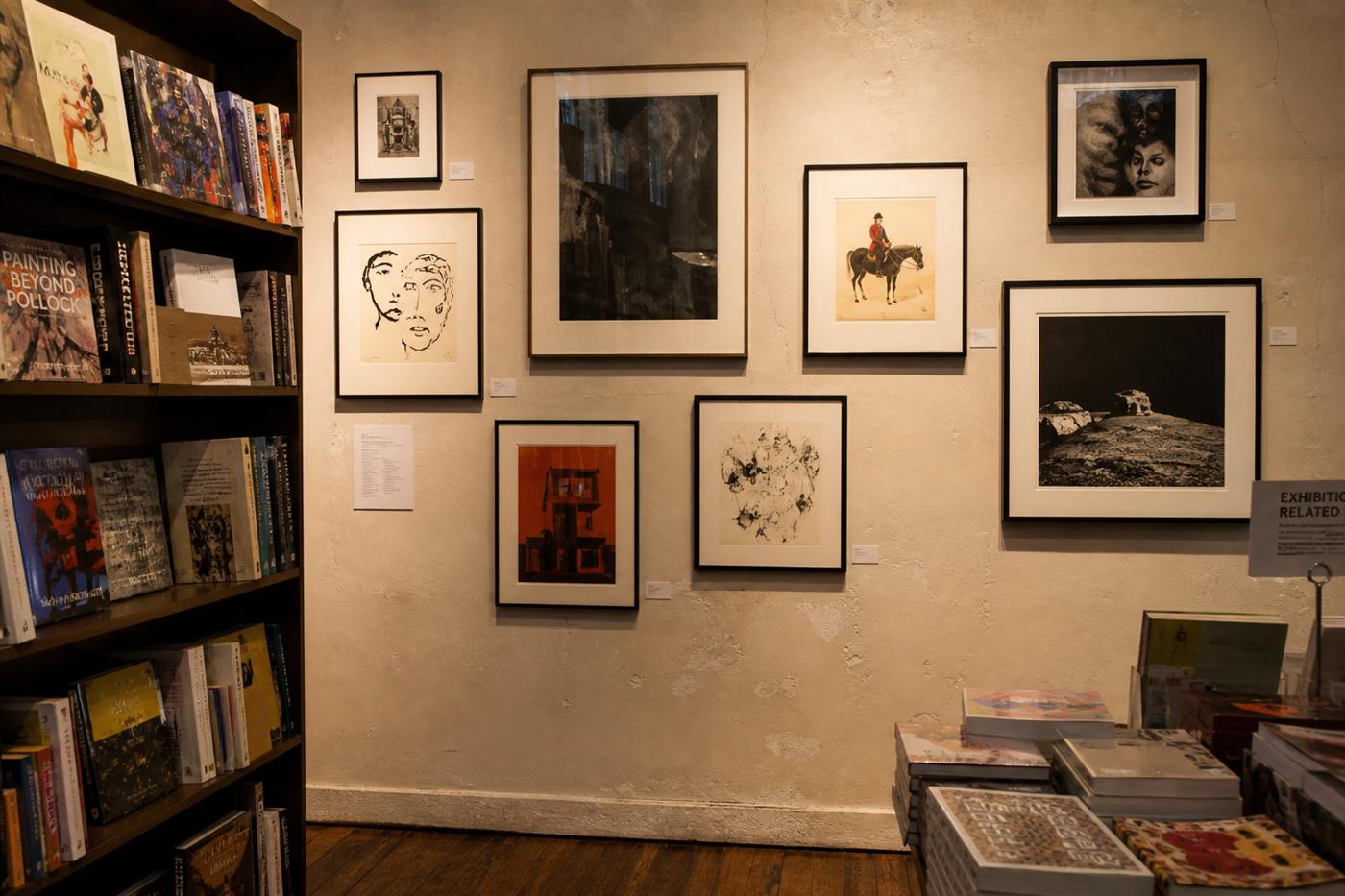 Framed artwork arranged on a warm gallery wall